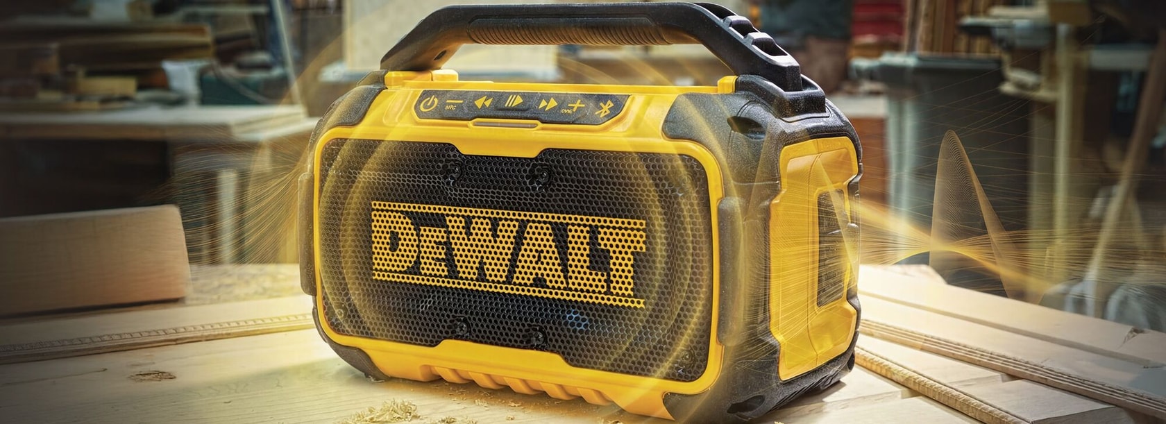 DEWALT portable Bluetooth speaker on a workbench in a workshop setting.